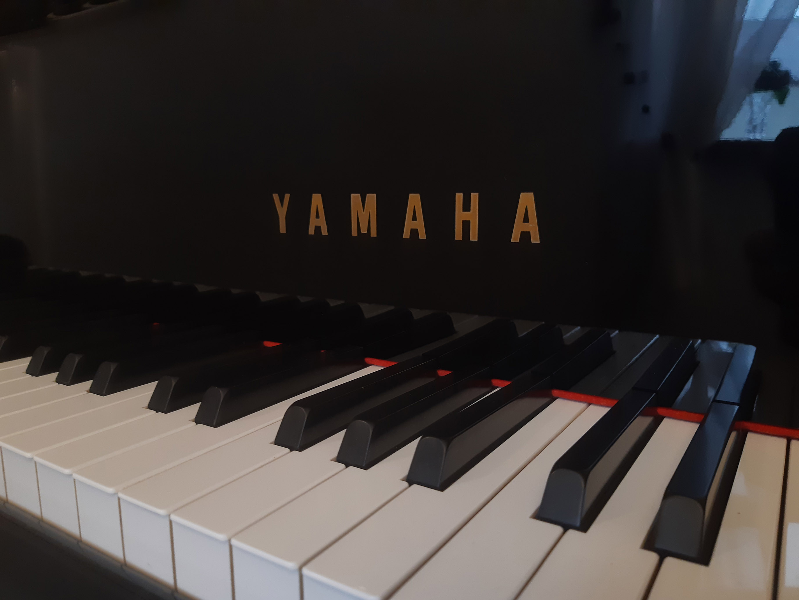 a close up image of the Yamaha grand piano keys at the Just Piano tuition studio